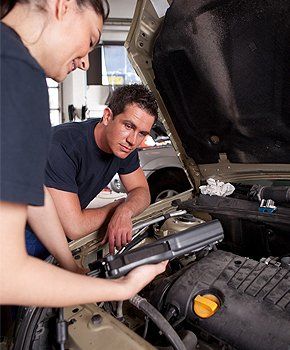 Mechanics performing computerized auto check up