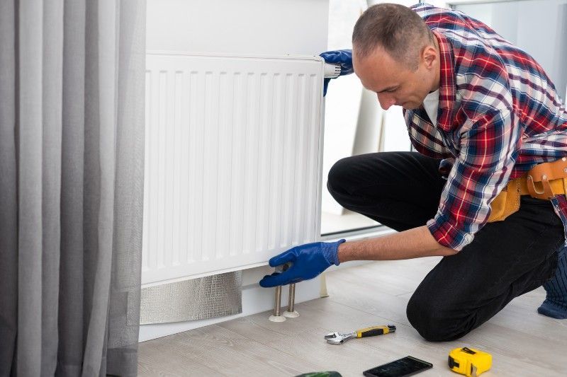 Technician Checking the Heater Home Heating Installation Services in Volusia & Flagler Counties, FL