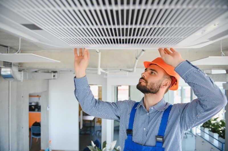 Technician Installing New AC Unit in Volusia & Flagler Counties, FL