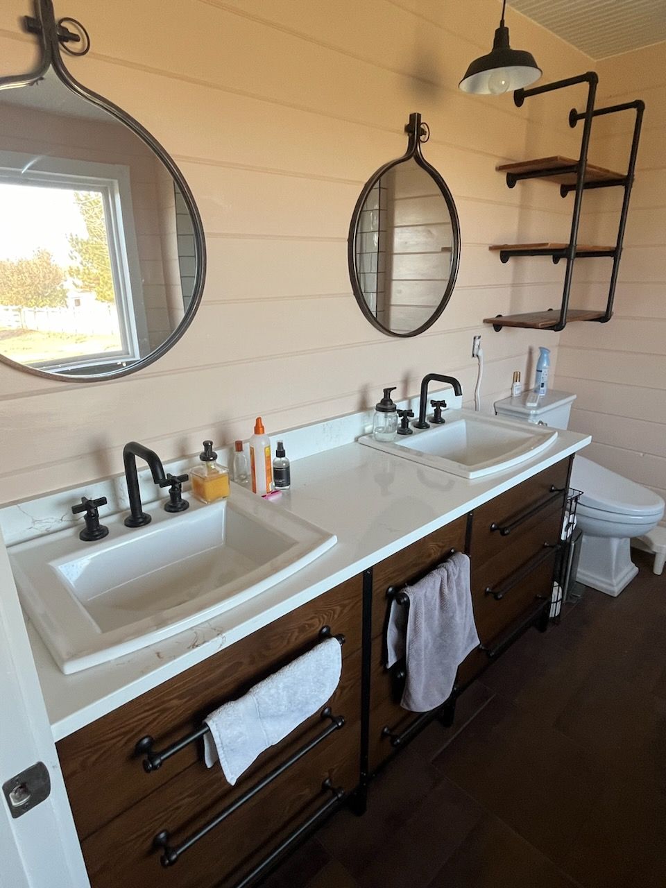 A bathroom with two sinks and two mirrors