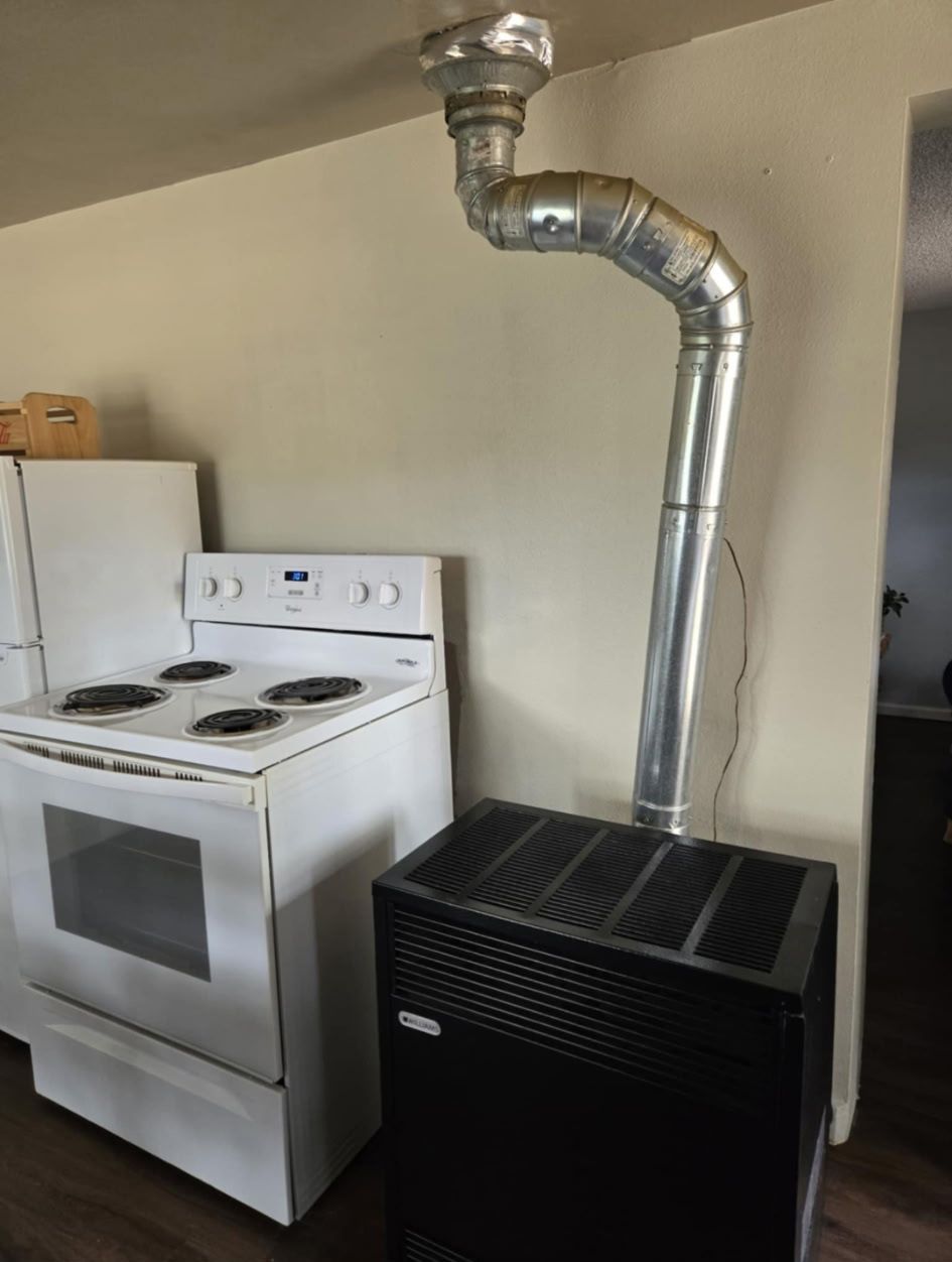 A white stove with a chimney attached to it