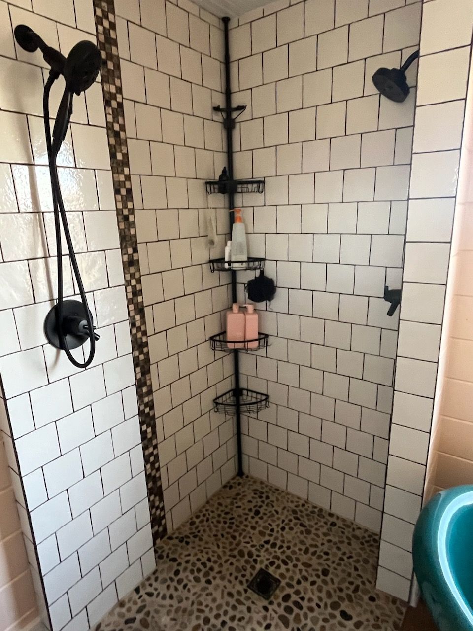 A bathroom with white tiles and a walk in shower