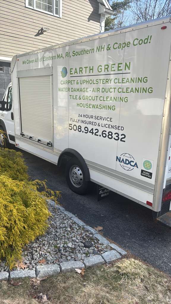 White Earth Green service van parked on a driveway with company contact information and cleaning services listed.