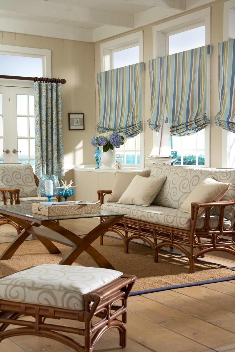 A living room with a couch , chairs , coffee table and ottoman