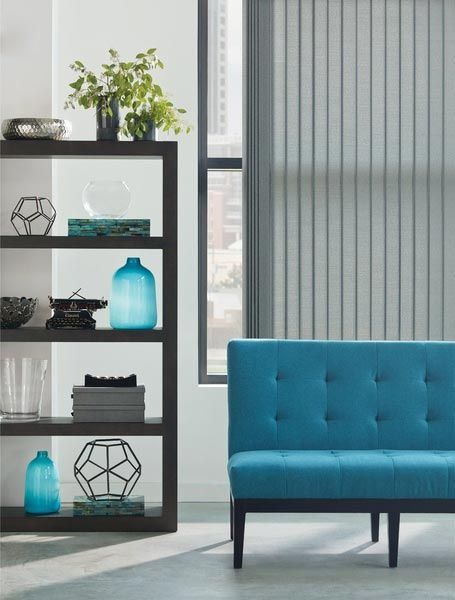 A living room with a blue couch and a bookshelf
