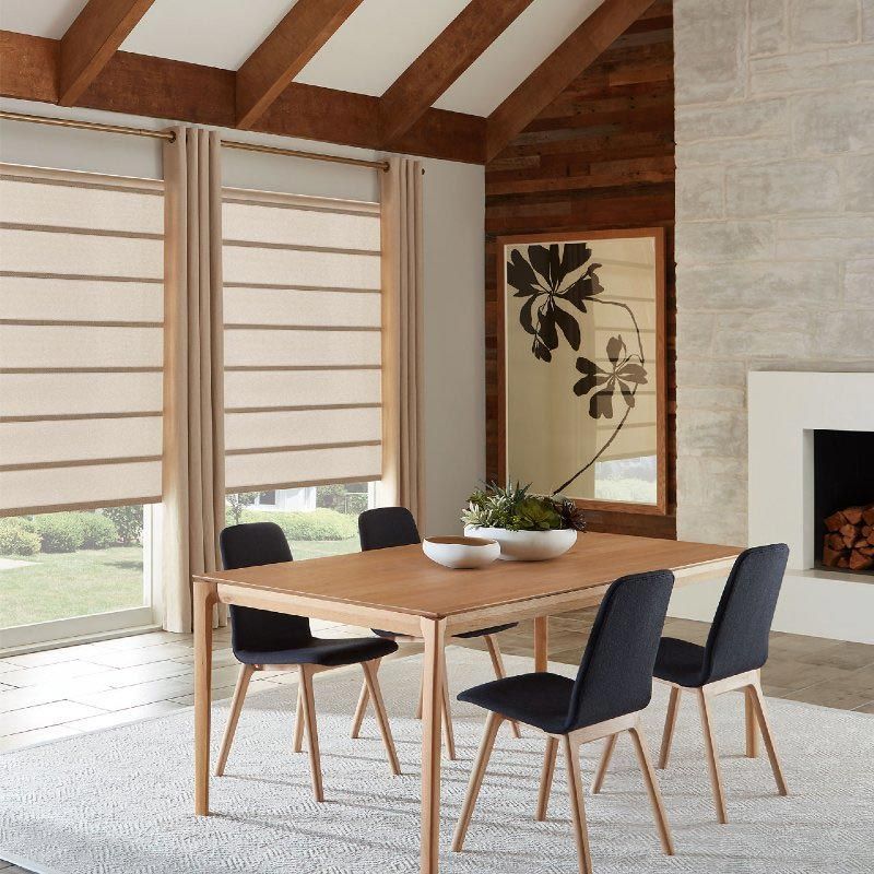 A dining room with a table and chairs and a fireplace