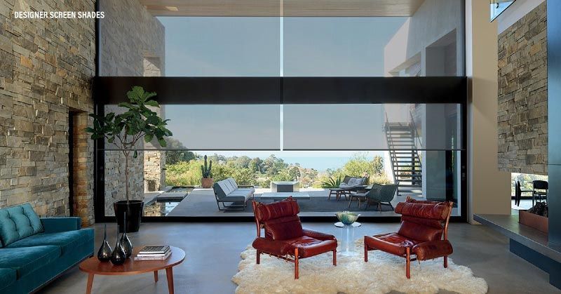 A living room with two red chairs and a blue couch