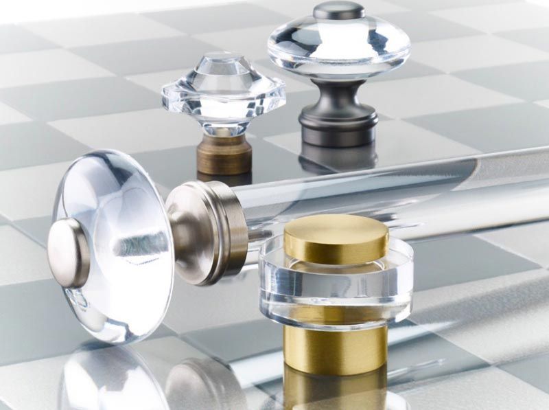 A chess board with clear and brass pieces on it