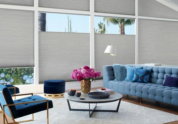 A living room with a blue couch and blue chairs