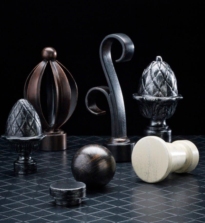 A group of curtain poles are sitting on a table.