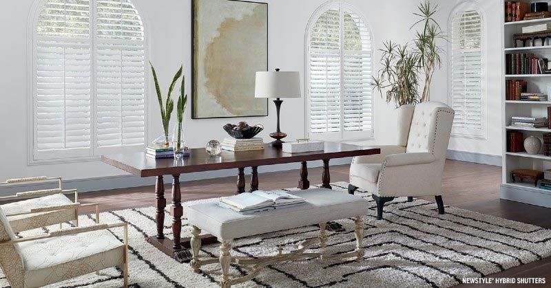 A living room with a table , chairs , and a bench.