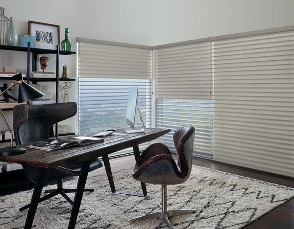 A home office with a desk , chair and computer.