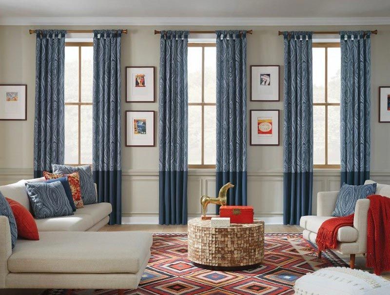 A living room with a couch , chairs , and a coffee table.