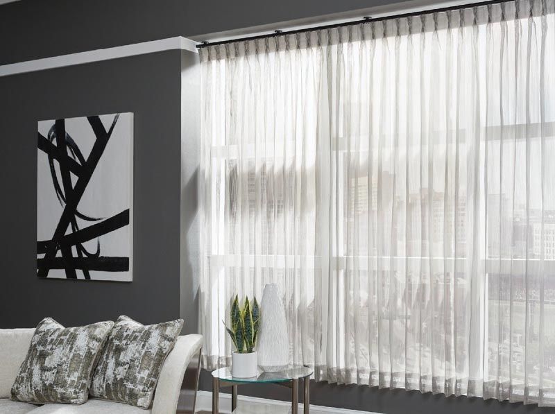 A living room with a couch , table , and a painting on the wall.