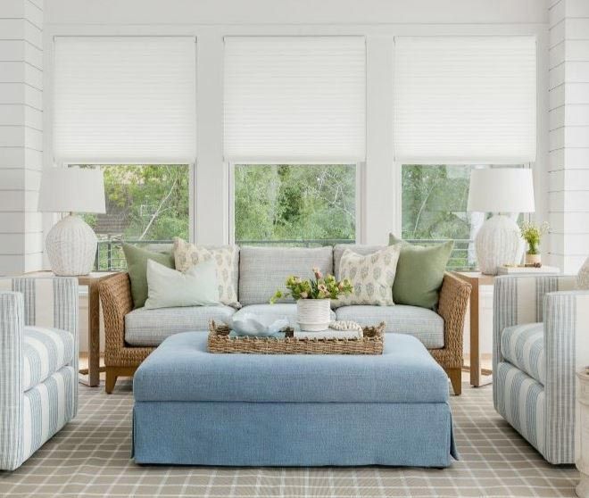 A living room with a couch ottoman and chairs