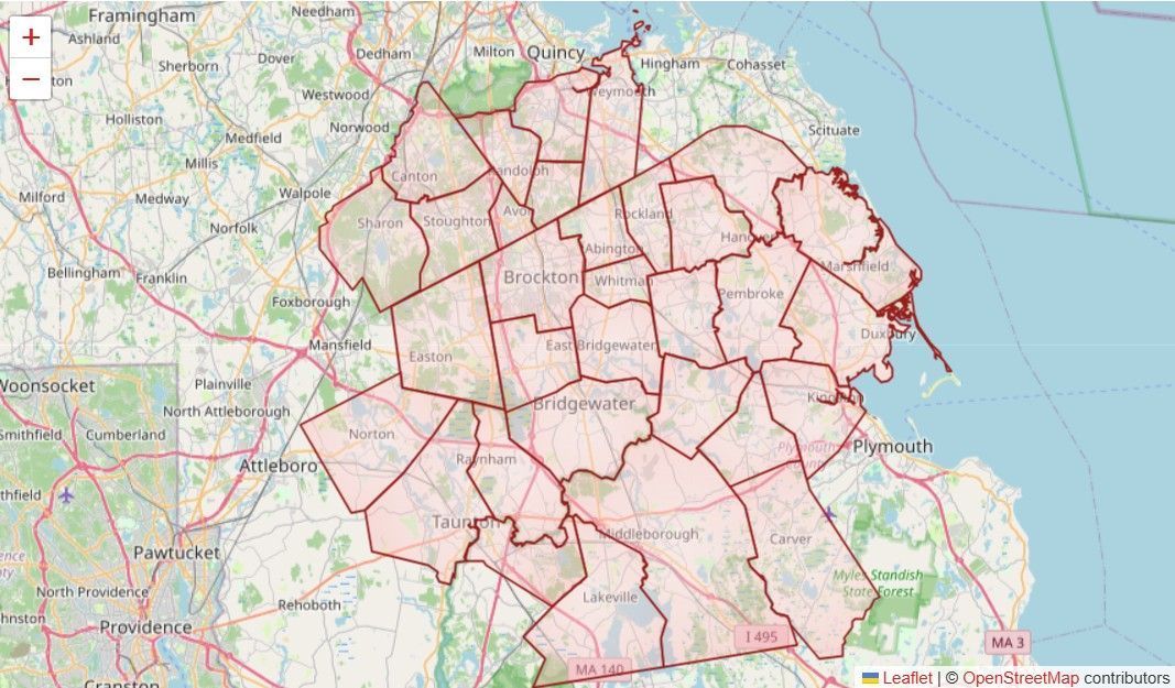 Map of a coastal city with red outlined districts and streets over a pale base map.