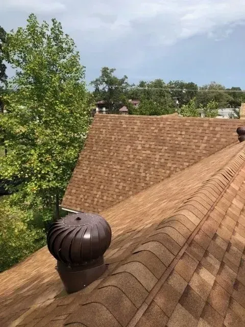 A roof with a wind turbine on top of it