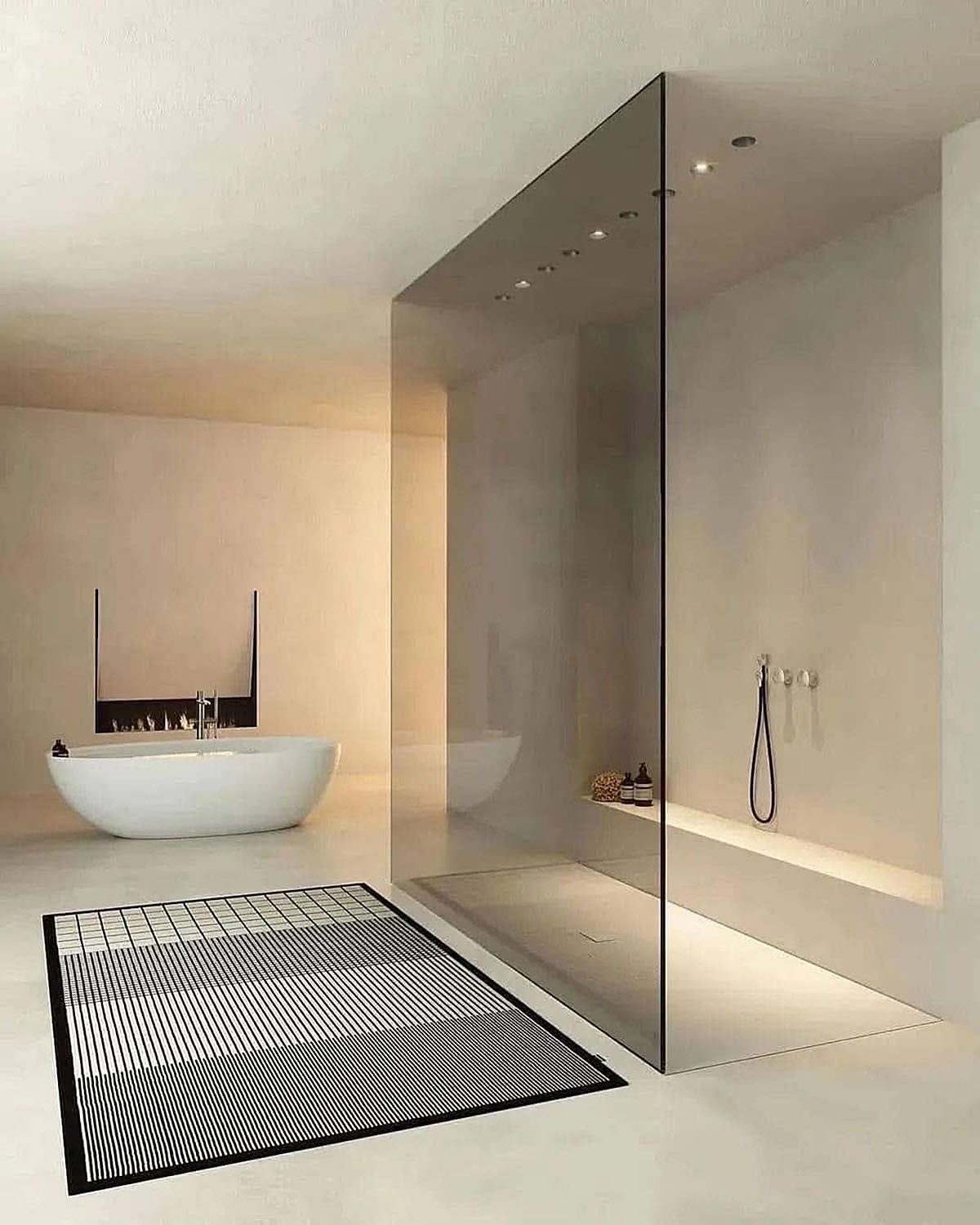 Modern minimalist bathroom with a freestanding tub, glass shower wall, and black-and-white rug.