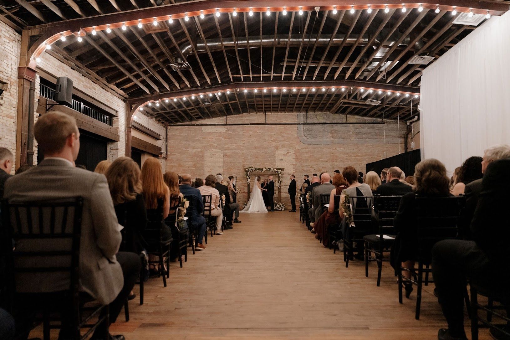 Seated guests look on as the wedding ceremony proceeds.