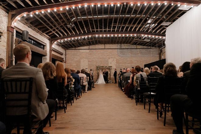 Seated guests look on as the wedding ceremony proceeds.