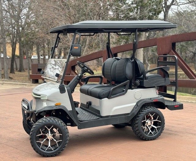Nomad XL: Gray golf cart with black roof, lifted, on paved path.