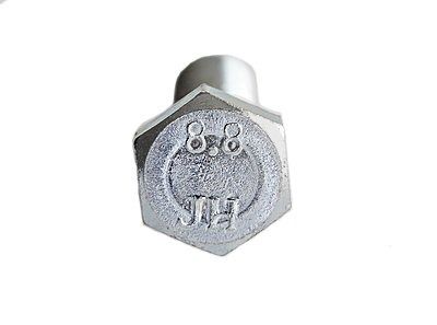 Metal hex bolt head with embossed markings on a white background