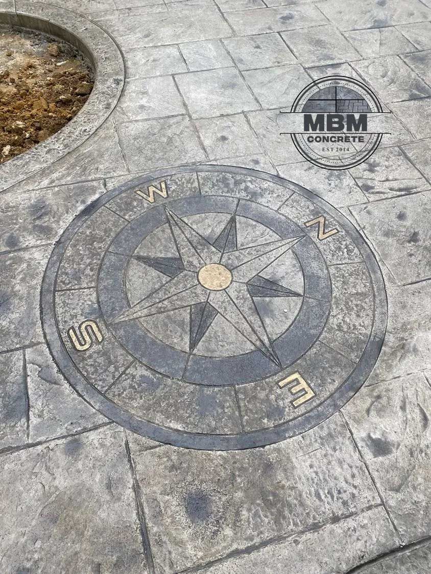 Stamped concrete with a compass rose design.