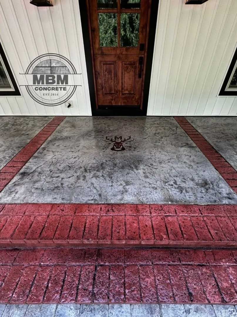 Concrete porch with brick border and doorway.