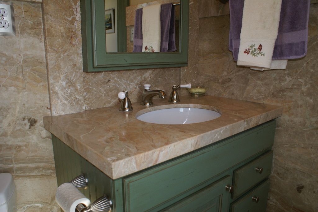 A stylish bathroom showcasing a sleek sink and a mirror, enhancing the room's contemporary design.