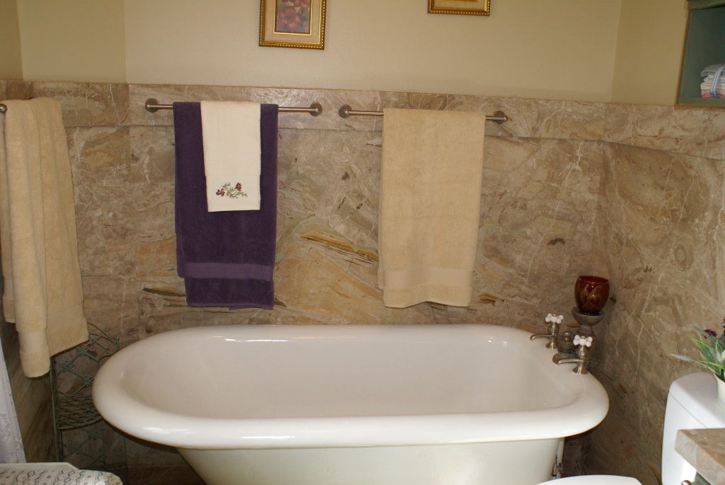 A bathroom sink, reflecting the faucet and toiletries on the counter.