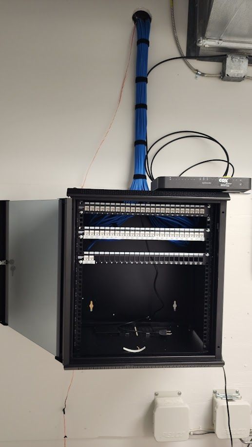 A black cabinet with a lot of wires coming out of it.