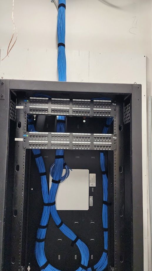 A server rack with blue wires coming out of it.