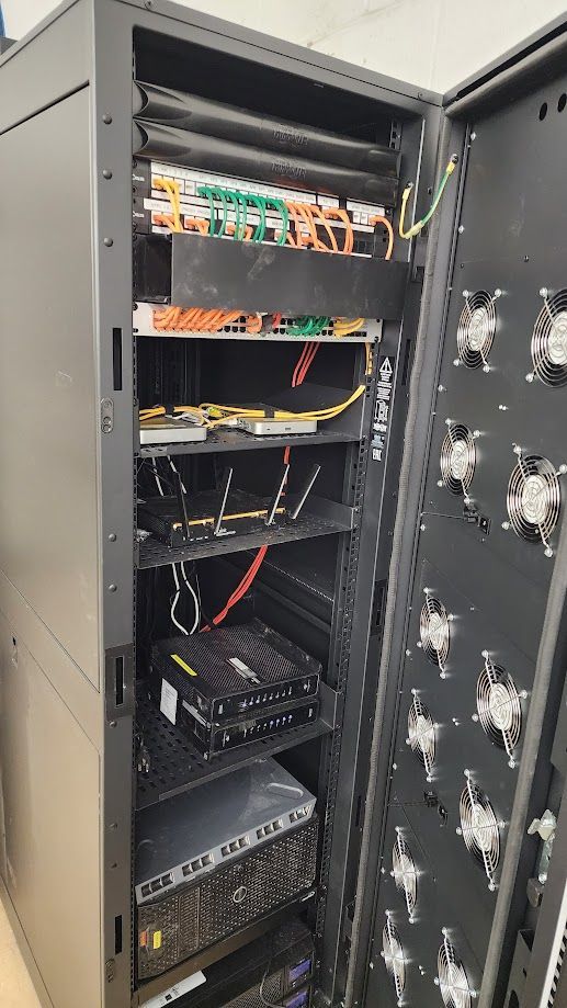 A server rack with a lot of wires coming out of it.