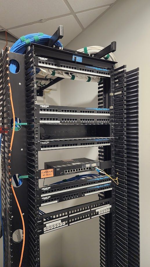 A server rack with a lot of wires on it.