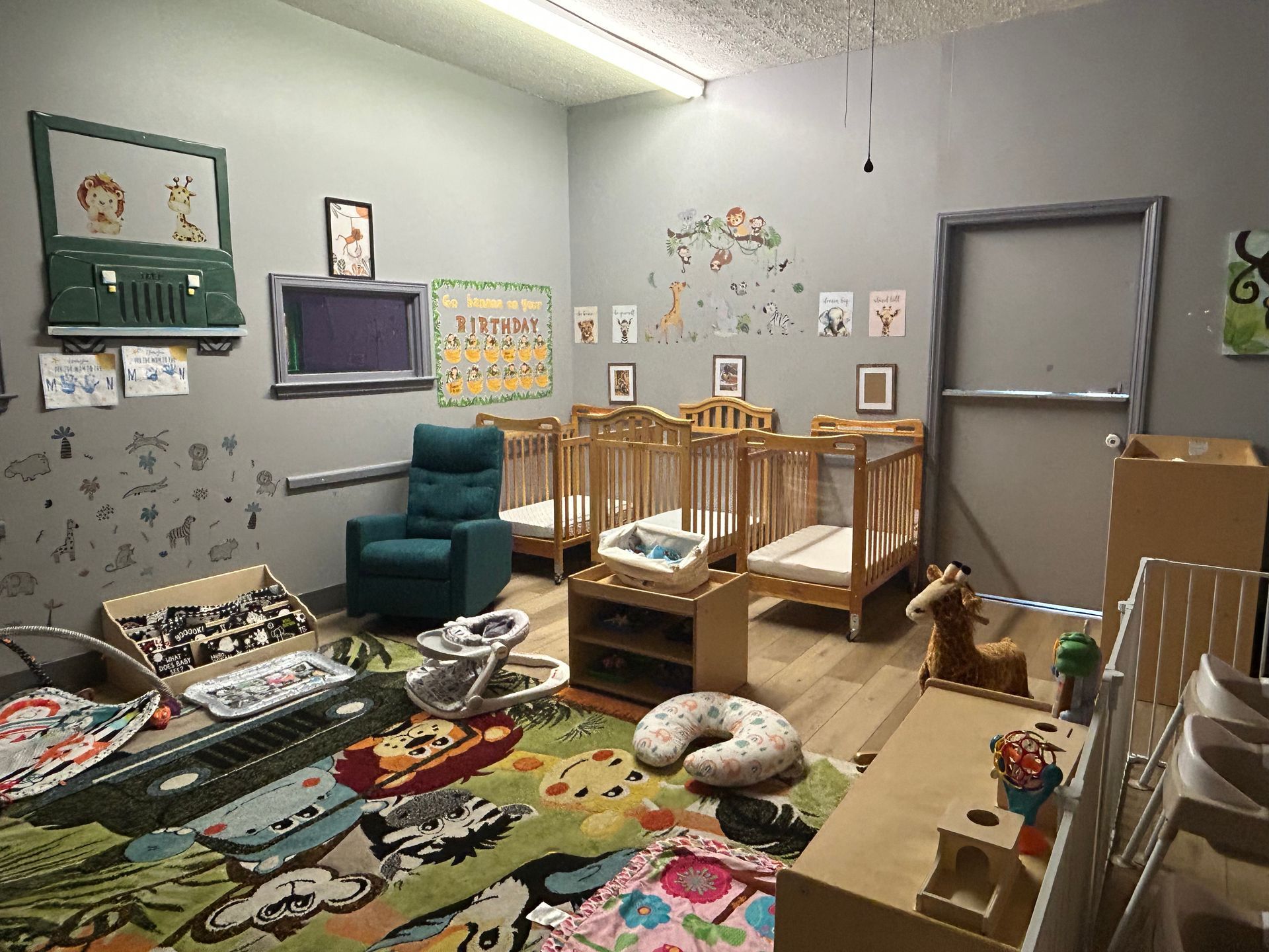 A nursery room with cribs, toys, and a rocking chair, light and colorful.