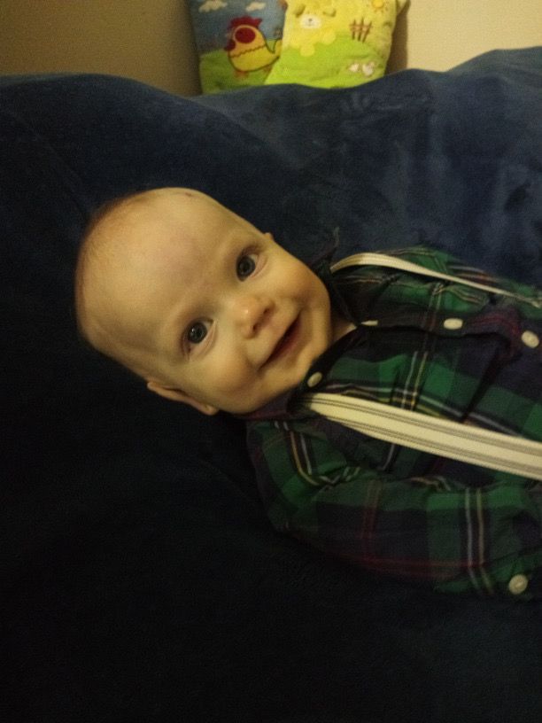Baby wearing plaid shirt and suspenders