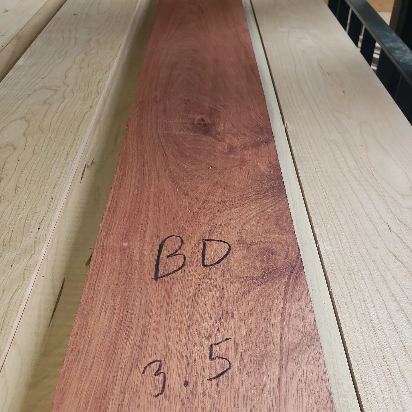 A dark reddish-brown wooden board marked 