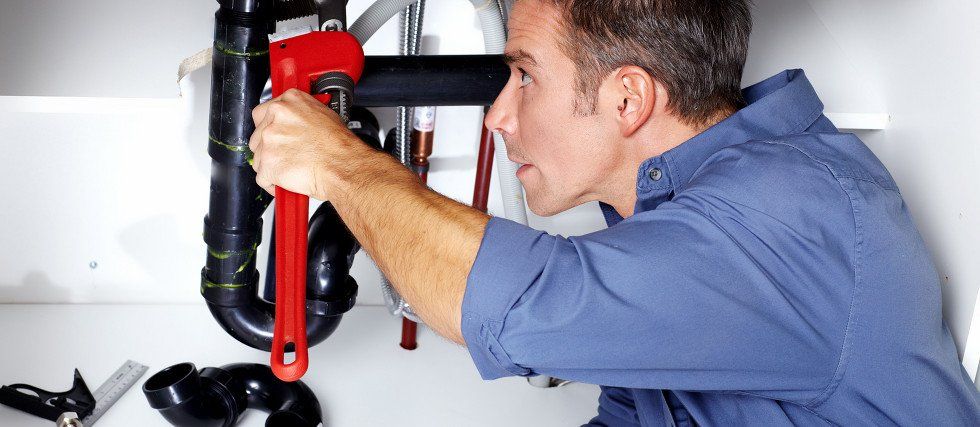 Plumber fixing a pipe