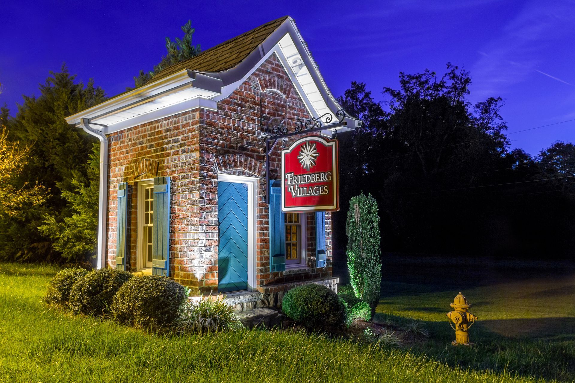 Small brick building with a sign that reads 
