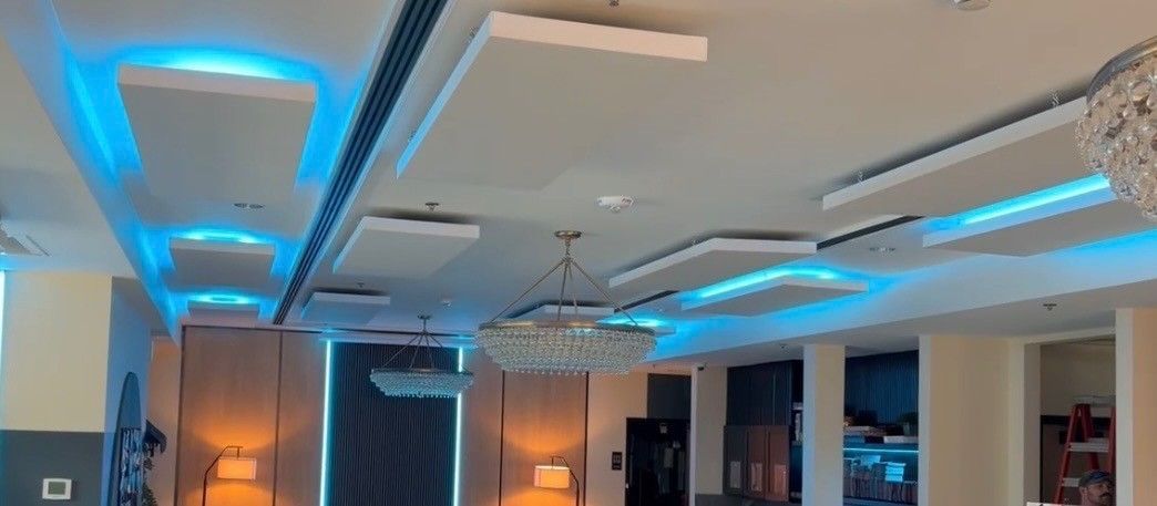 Modern lobby with blue LED ceiling lights and warm orange wall accents