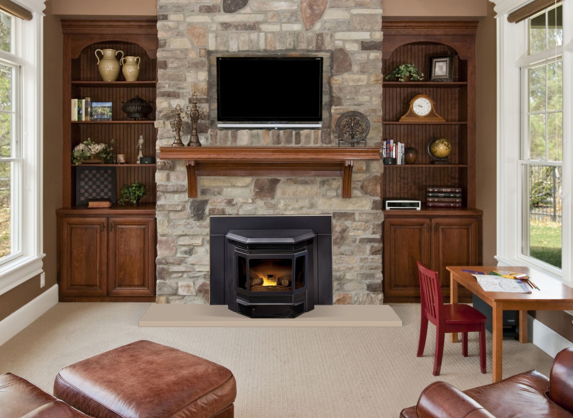 Living room with stone fireplace, built-in bookshelves, TV, and brown leather furniture.