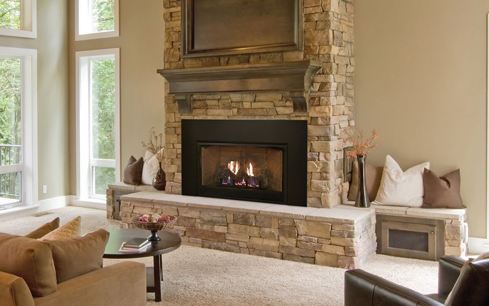 Cozy living room with stone fireplace, burning flames, and neutral-toned furniture.