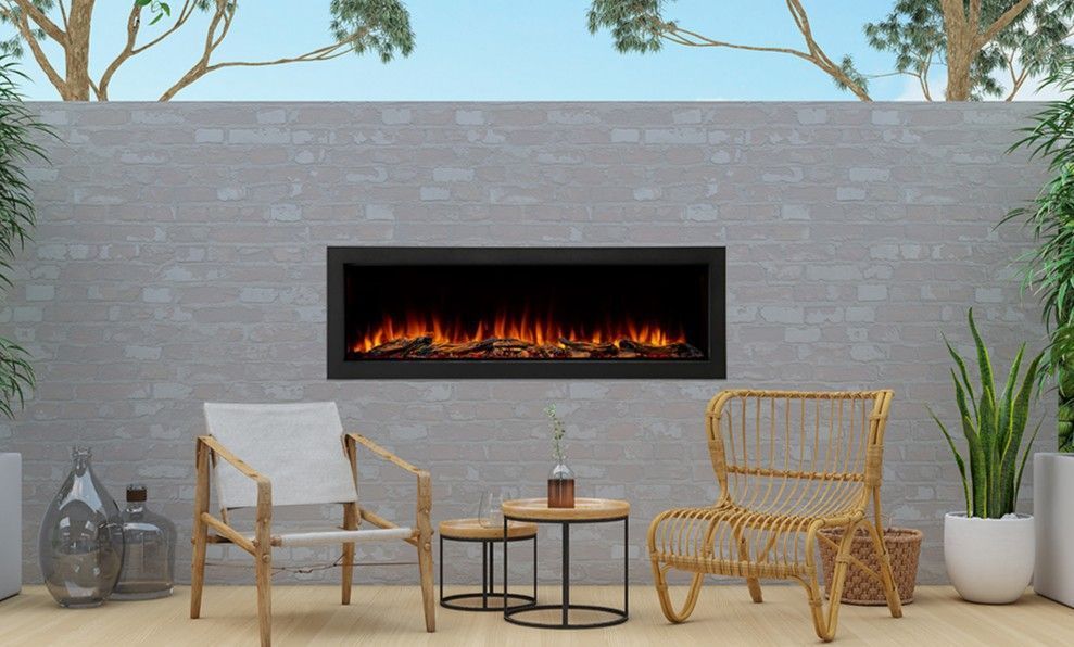 Outdoor seating area with a modern fireplace, grey brick wall, and potted plants.