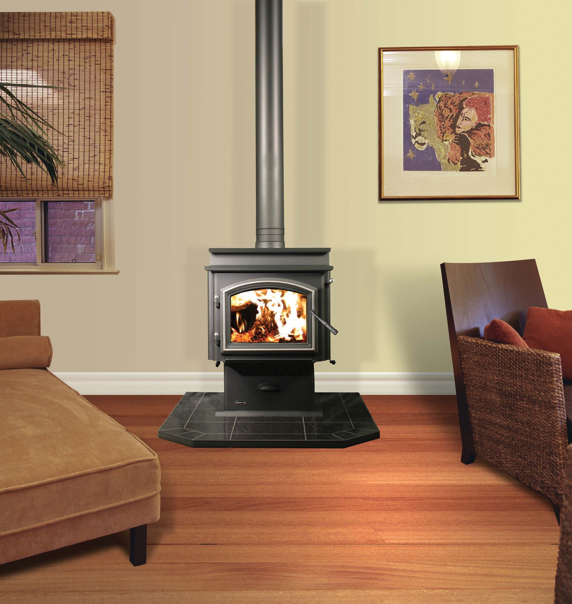 Wood-burning stove in a living room, with a lit fire, surrounded by furniture and a window.