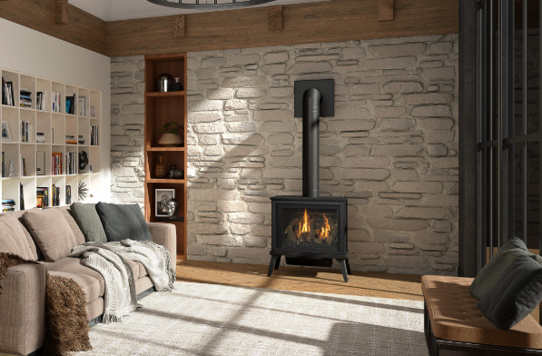 Cozy living room with stone fireplace, wood beams, bookshelf, sofa, and chair.