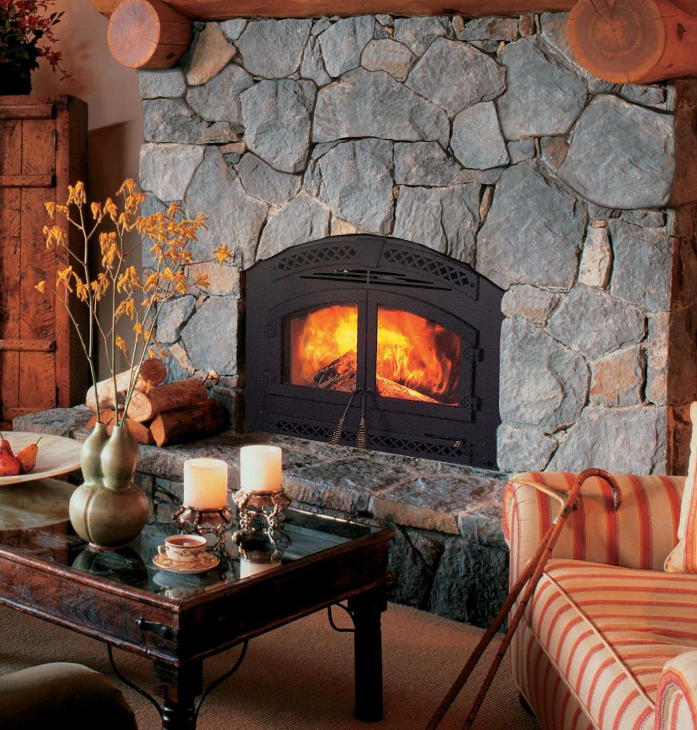 Living room with fireplace, brown leather sofa, and two armchairs; neutral tones.