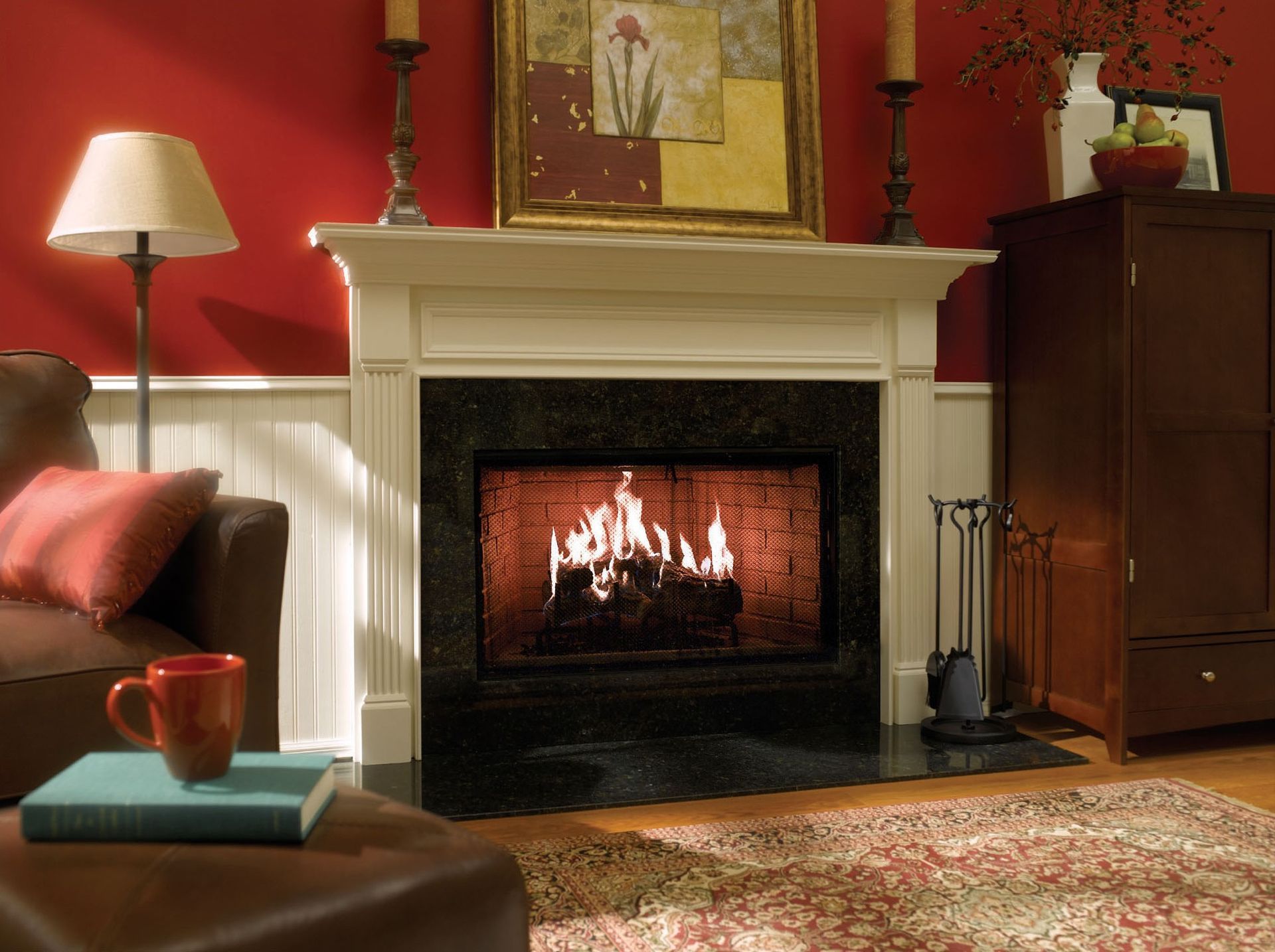 Cozy living room with a lit fireplace, red wall, and brown furniture.