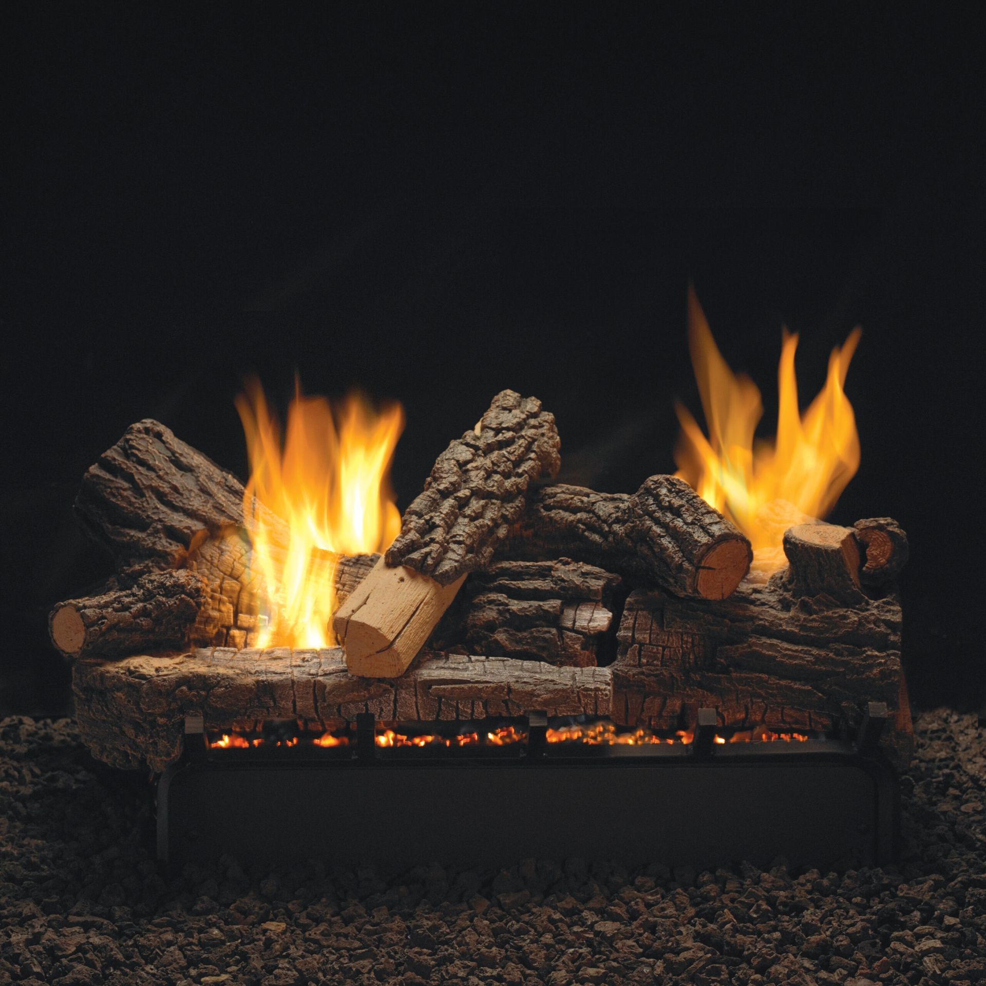 Burning gas fireplace with ceramic logs. Flames against a dark background.