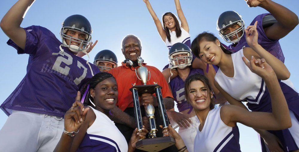 group of people holding a Trophy