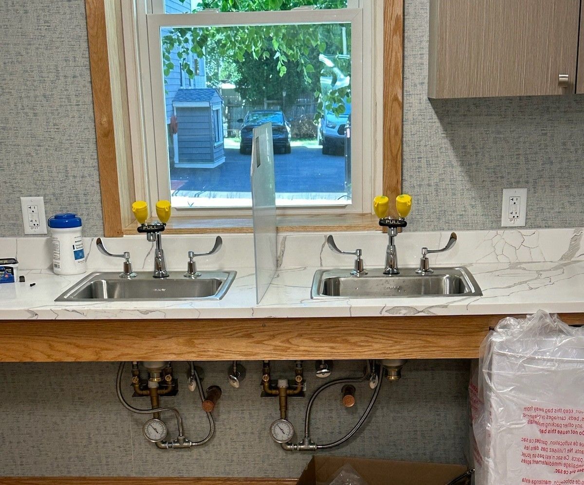 A kitchen with two sinks and a window